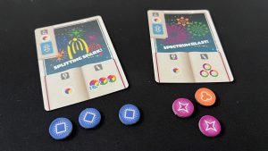 Two Pyrotechnics cards with the tokens required to pay for the Showcase action of each one. Courtesy of Gaming Trend.